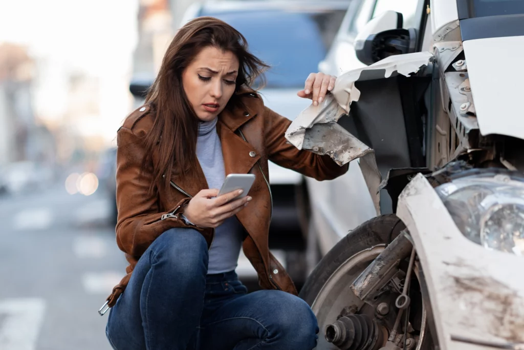 Car Insurance: 3 Important Steps to Do After a Car Accident and How Insurance Can Help 1 young sad woman text messaging smart after car crash road